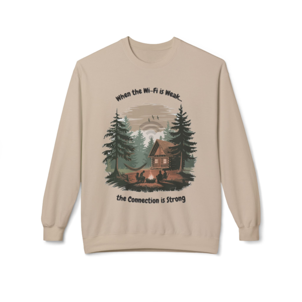 10162539703565773186_2048.webp Beige crewneck sweatshirt with a graphic of a log cabin in the woods, a campfire, and the text 'When the Wi-Fi is weak... the Connection is strong.'