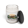 13087895727183689313_2048.webp 9oz scented soy candle with a label featuring a rustic homestead scene of a farmhouse, windmill, and stream, under the "Quiet Meadows Homesteading" brand.
