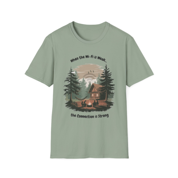 Light green t-shirt with a graphic of a cabin in the woods, a campfire with people sitting around it, and the text 'When the Wi-Fi is Weak... the Connection is Strong'.