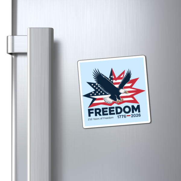 15272808049572075460_1200.webp Square magnet on a refrigerator featuring an eagle flying in front of an American flag starburst, with the word "FREEDOM" and the dates 1776-2026.