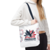A woman holds a white tote bag with a patriotic design featuring an eagle, stars, stripes, and the text 'Freedom 250 years of freedom - 1776 to 2026'.