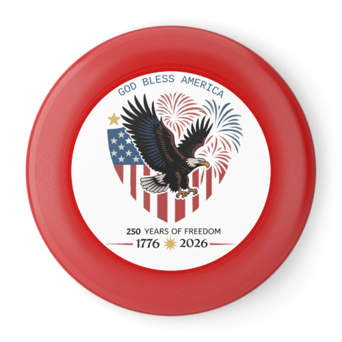 Red frisbee with a patriotic design featuring a bald eagle, the American flag, fireworks, and the text 'God Bless America' and '250 Years of Freedom 1776-2026'.