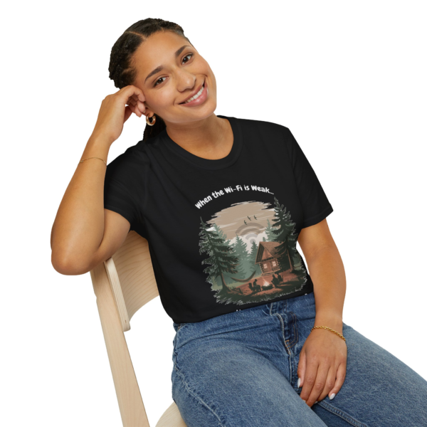 A smiling woman wearing a black t-shirt with the text "When the Wi-Fi is Weak..." above a graphic of a cabin in the woods.
