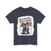 7673989457686494649_2048.webp T-shirt with an illustration of a man in overalls and hat, working while holding an American flag, with the text 'Born to be Free, Forced to Work'.