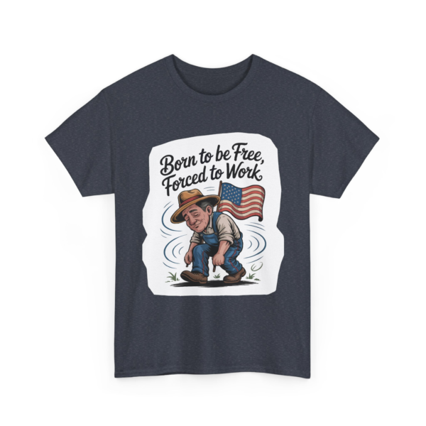 7673989457686494649_2048.webp T-shirt with an illustration of a man in overalls and hat, working while holding an American flag, with the text 'Born to be Free, Forced to Work'.