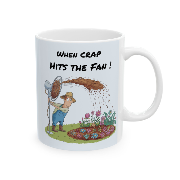 9198346731633240190_2048.webp Ceramic mug with a cartoon depicting a farmer operating a fan to spread manure onto a flower bed, with the text "When CRAP Hits the Fan!"